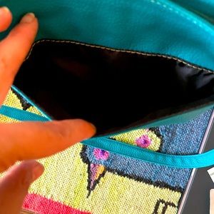 Turquoise leather crossbody bag.